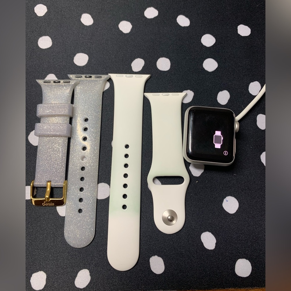Silver Apple Watch Series 3 38mm with white sports band, extra arm band